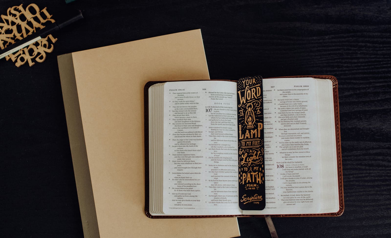 An open Bible marked with a scripture bookmark, prepared for study.